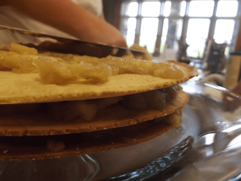 placing layers of apple stack cake