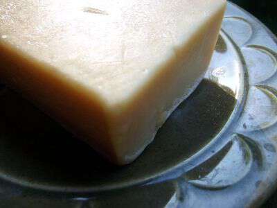 A woman soap maker stirs a boiling pot of lye soap at the Ozark