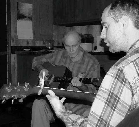 two men playing guitars