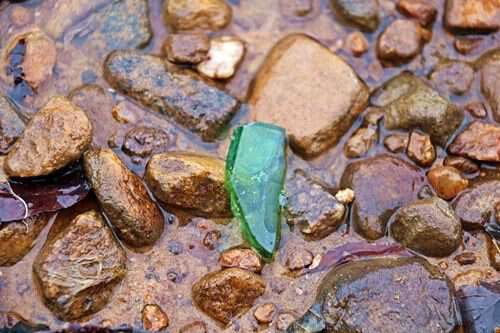 worn glass in lake