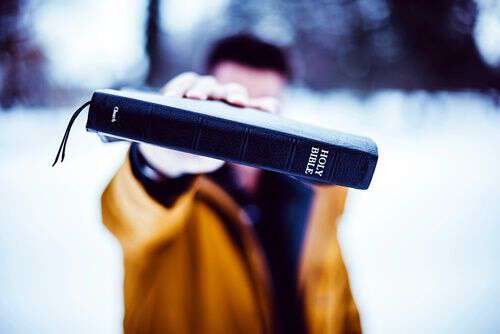 man holding bible