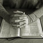 hands clasped in prayer