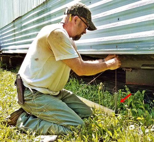 man using a home made plumb bob