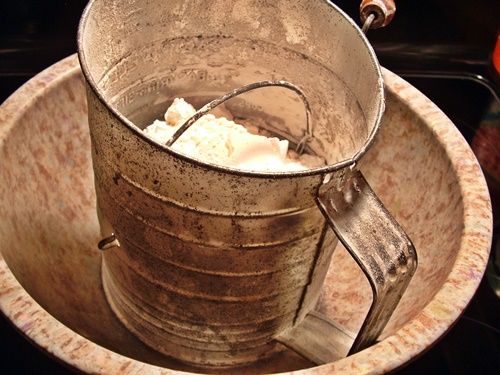 sifter of flour in bowl