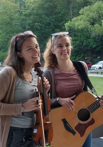 the pressley girls standing with guitar and fiddle.