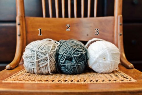 three skeins of yarn in chair
