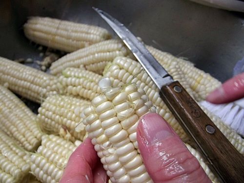 ears of shucked corn in a bowl