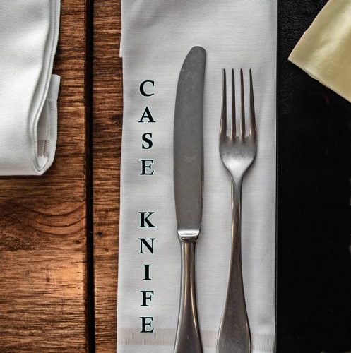 case knife and fork laying on napkin