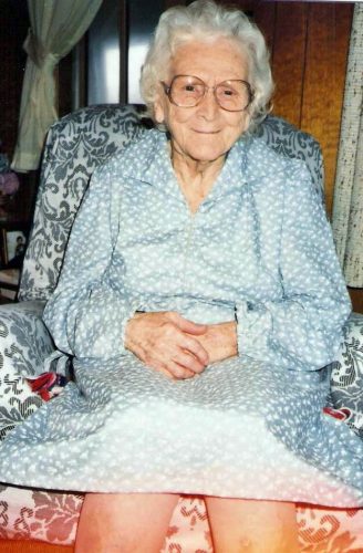 smiling elderly lady sitting in chair