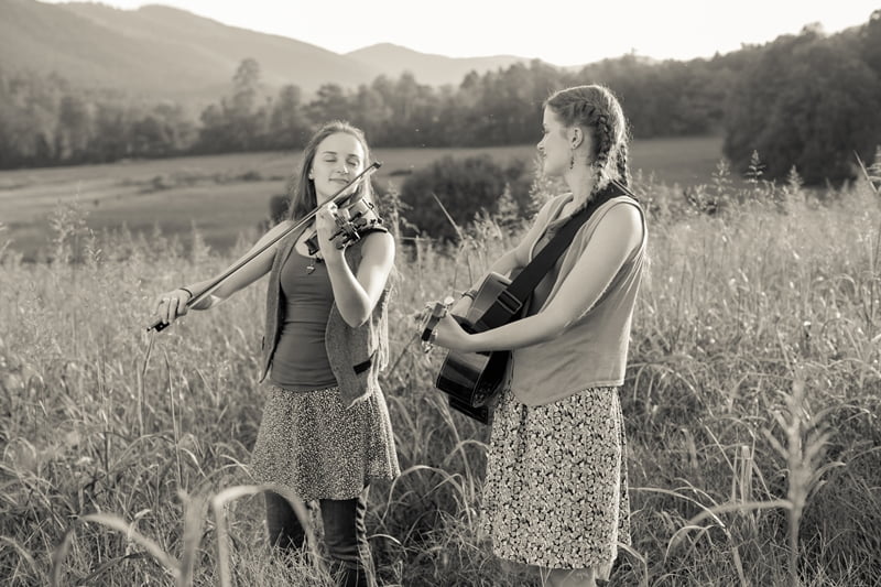 the pressley girls playing music in a field