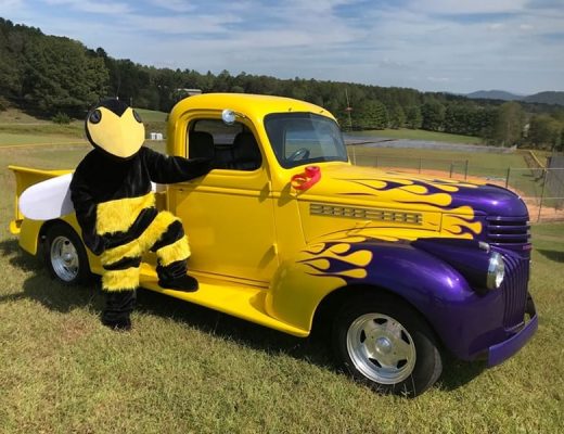 hornet mascot beside yellow truck