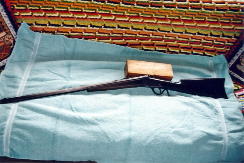 rifle on bed