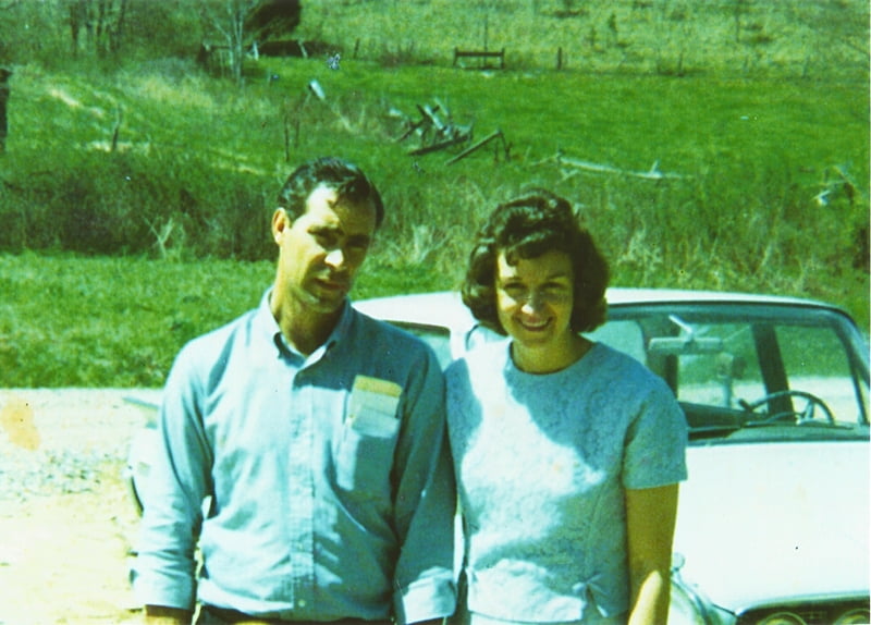 man and woman standing by car