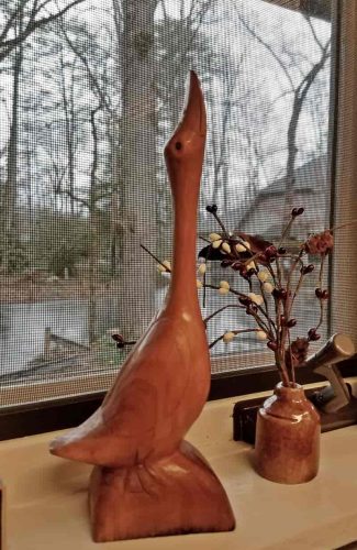 carved goose in window
