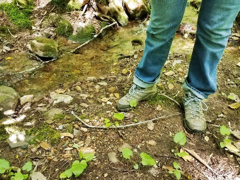 girl standing by creek