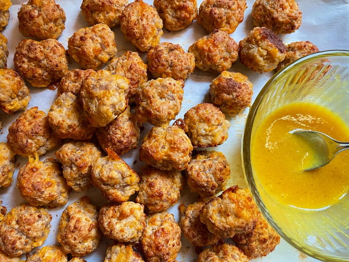 plate of sausage balls with dip