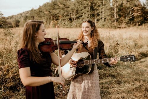 Corie and Katie with instruments in field
