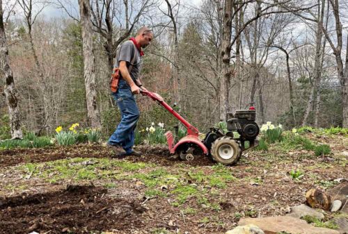 Matt using Pap's tiller in Garden