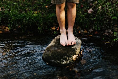 barefooted boy in creek