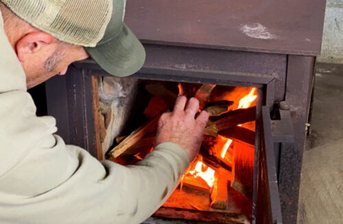 Matt building fire in woodstove