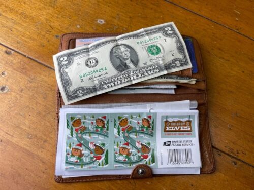 wallet with 2 dollar bill on it