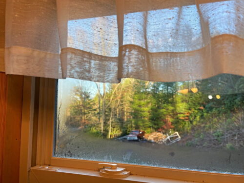 window with curtain and fogged panes