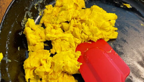 Cast iron pan of scrambled eggs