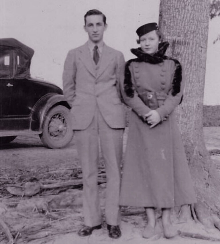 Couple standing by tree