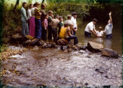 Pastor baptizing Tipper in Creek