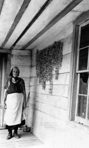 Woman on porch of old house