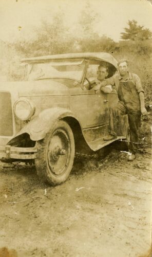 two men with old car