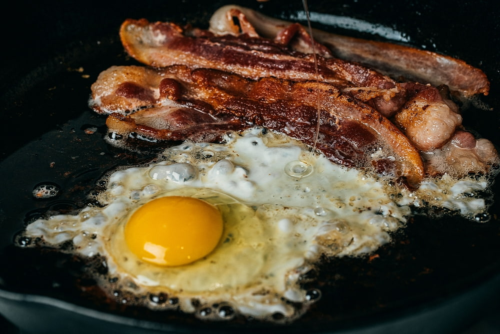 egg frying with bacon