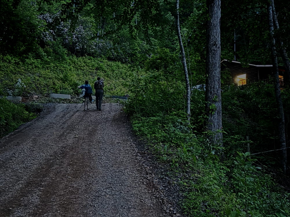 father, daughter, and grandson walking in the dark
