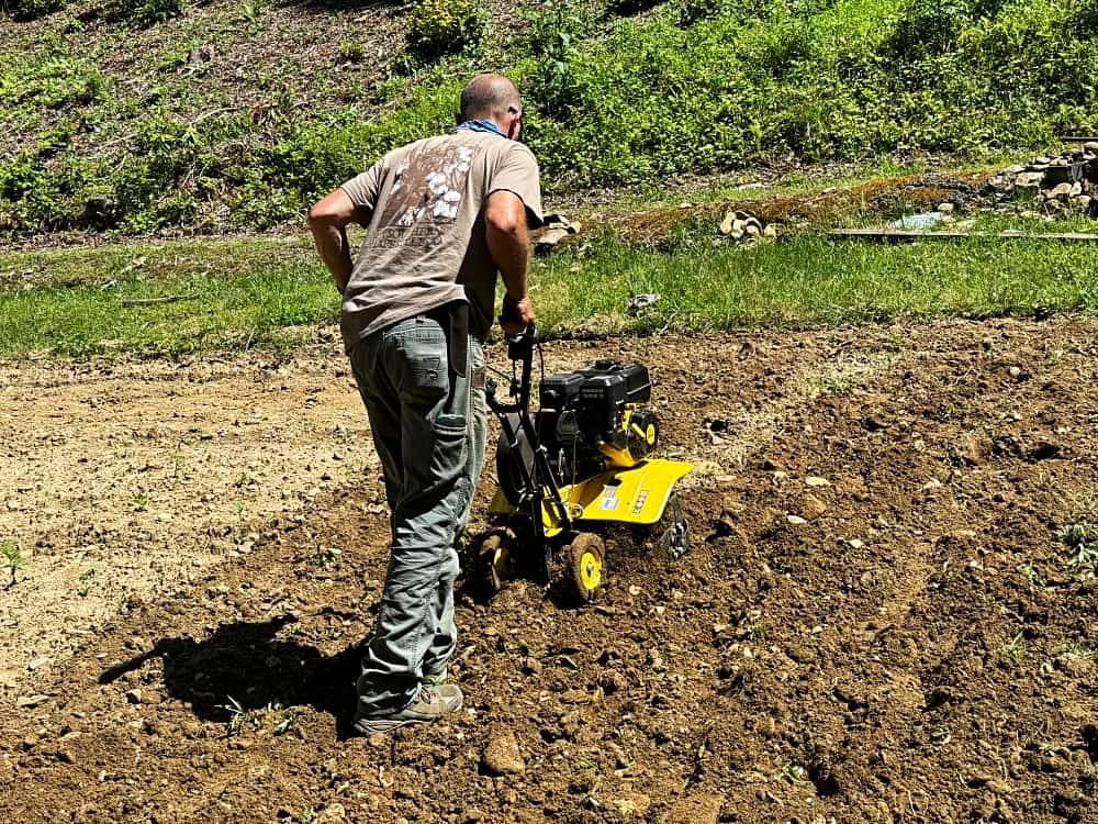 man tilling garden