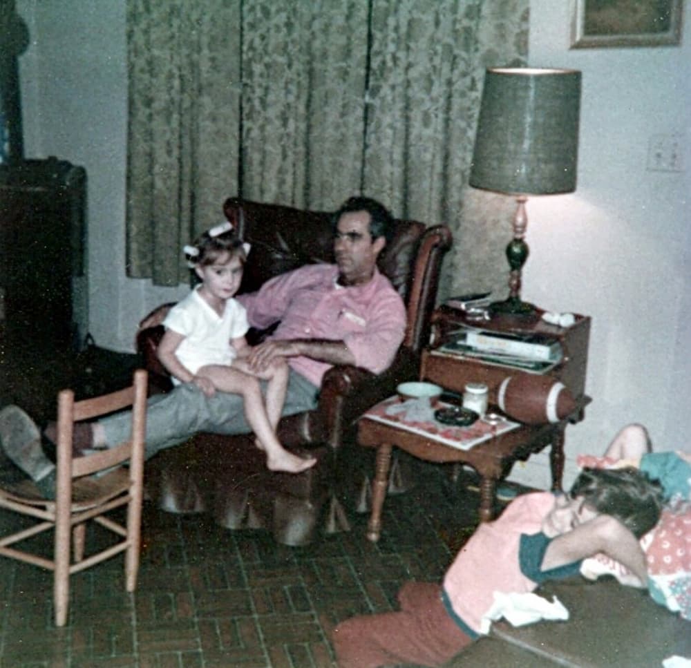 Man with daughter in lap