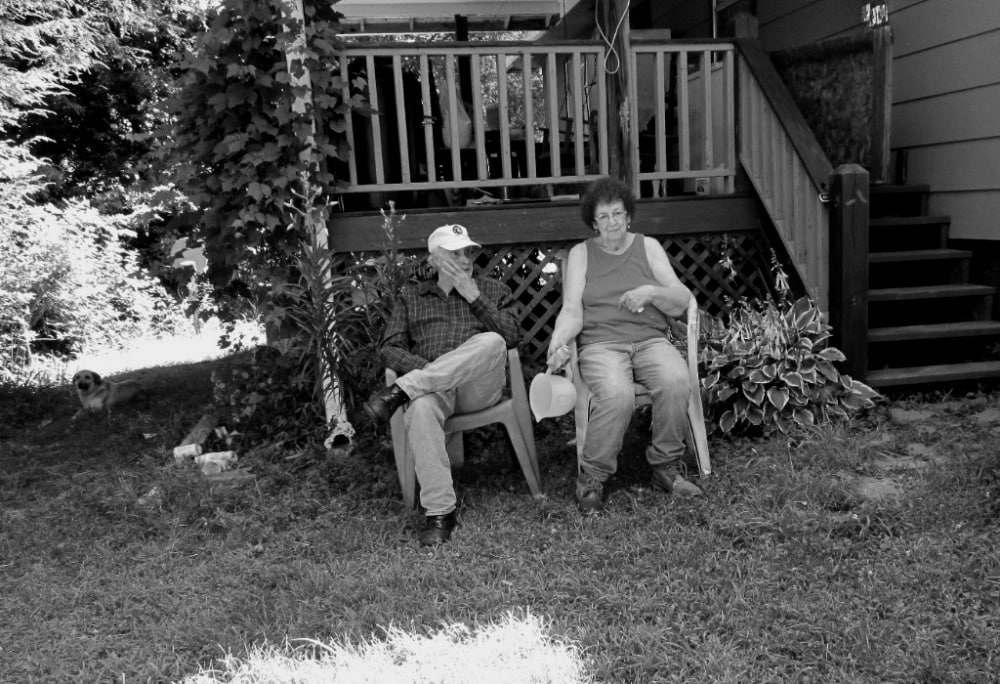 old married couple sitting outside