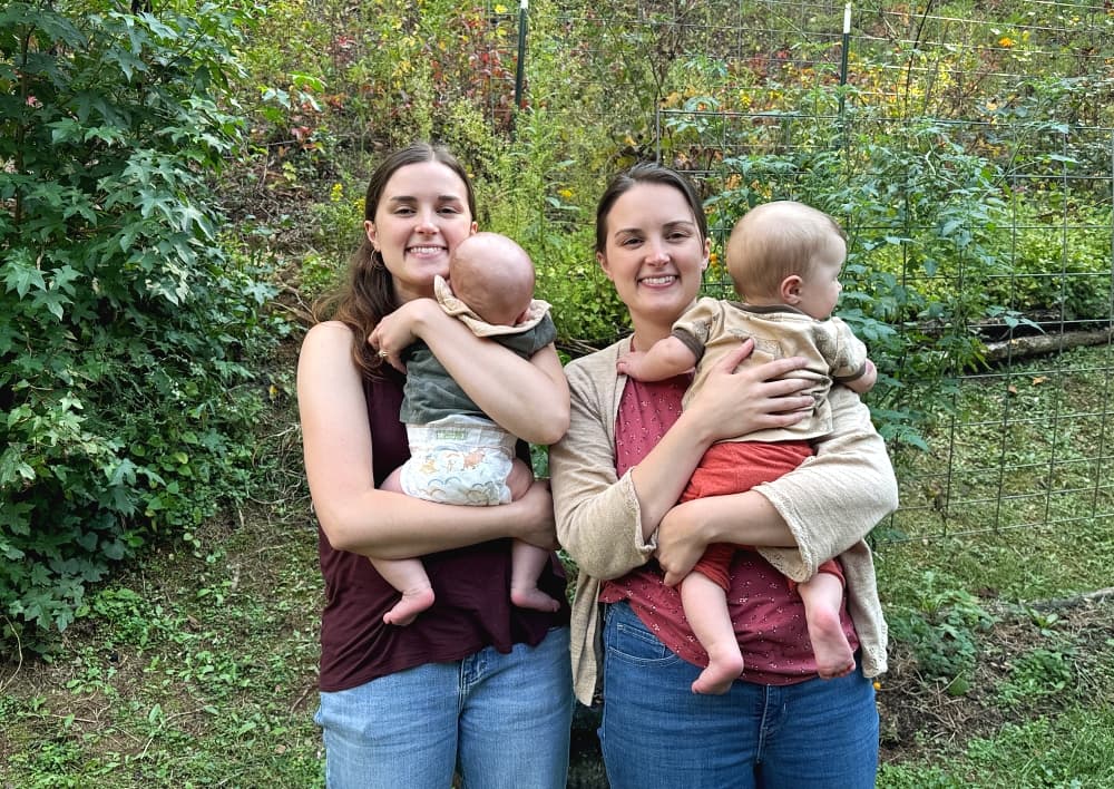 sisters holding babies