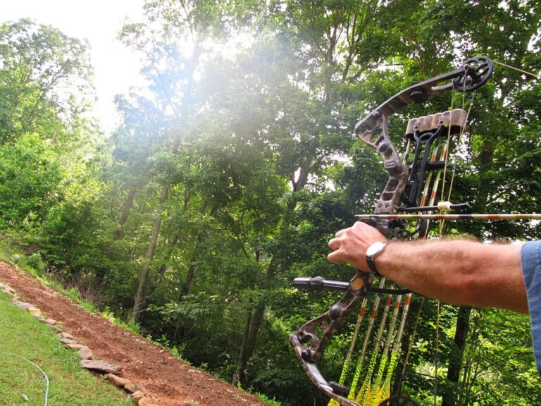 man with bow near garden