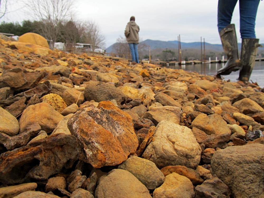 people walking over rocky terrain