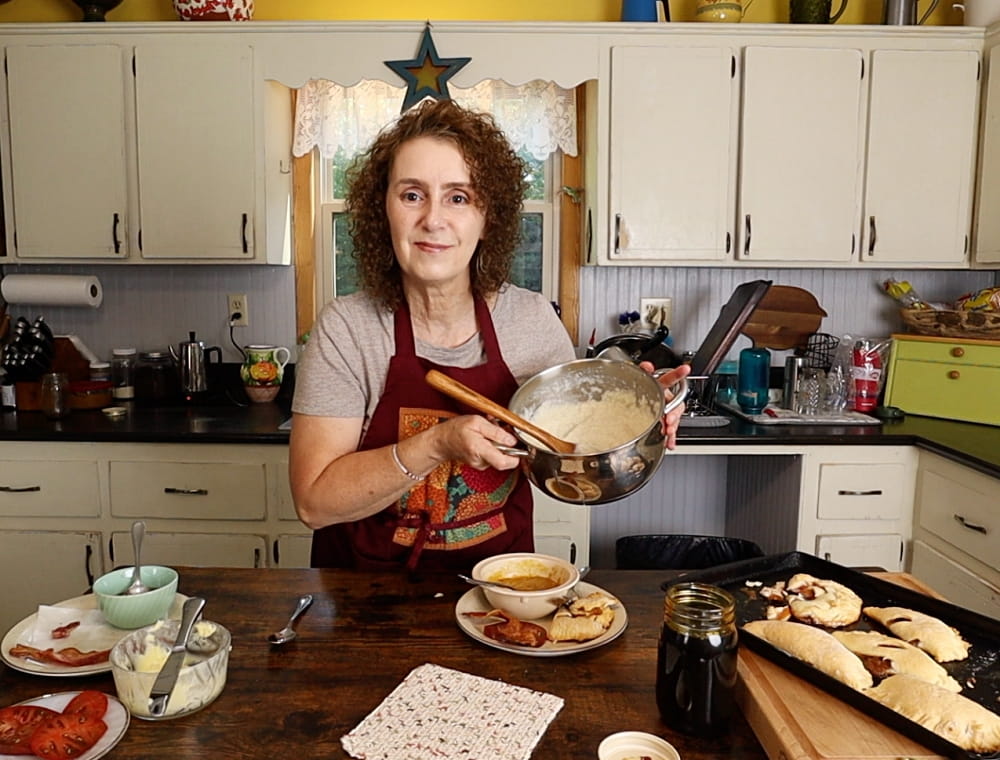 Woman holding pot of cornmeal mush