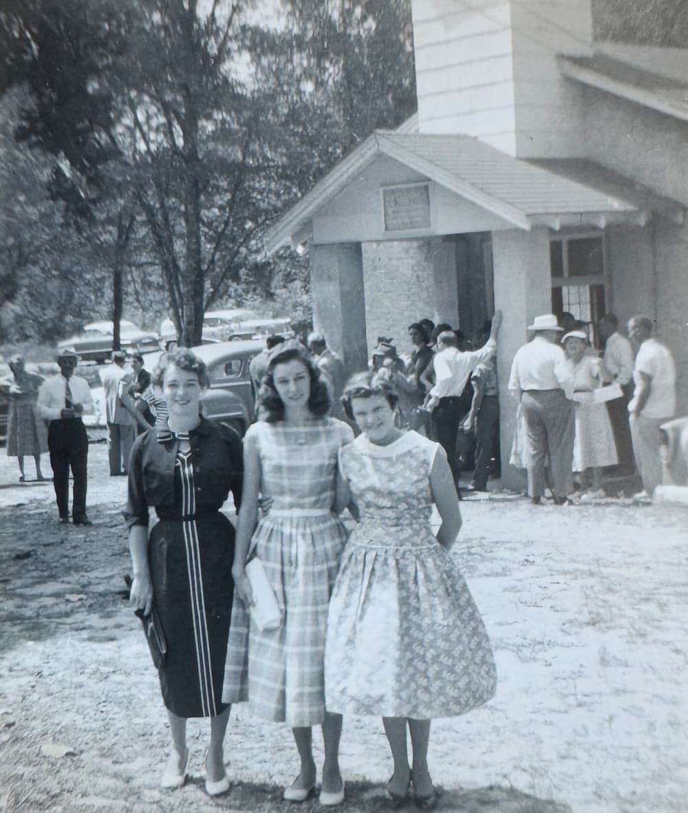 three girls in front of church in the 50s