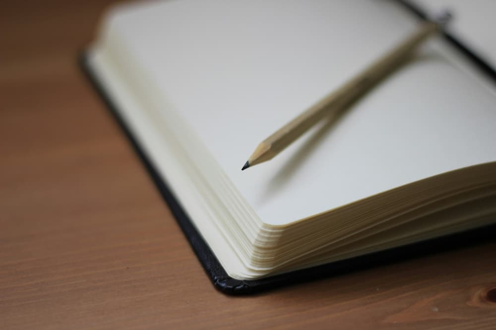 blank page of book with pencil