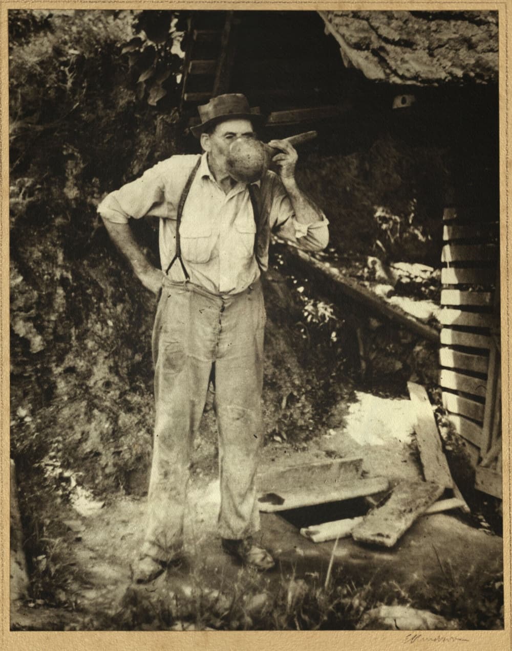 man drinking from gourd dipper