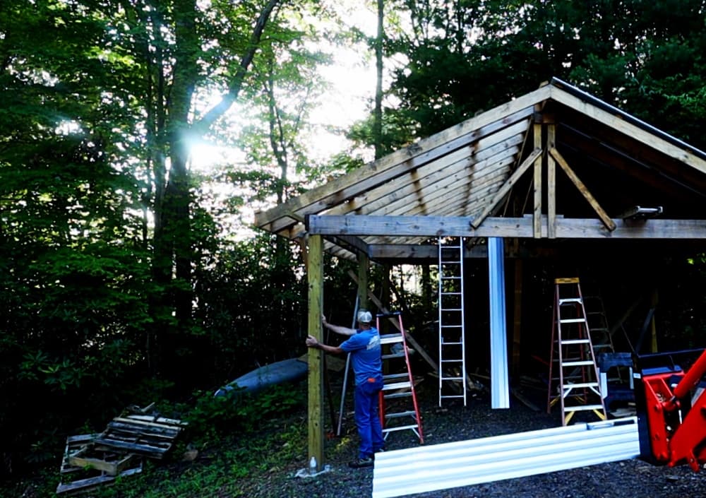 man standing by shed