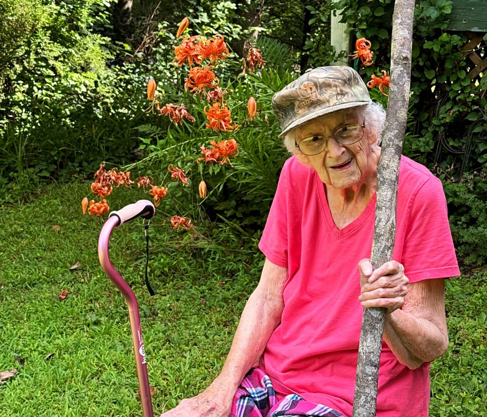 granny sitting in chair in garden