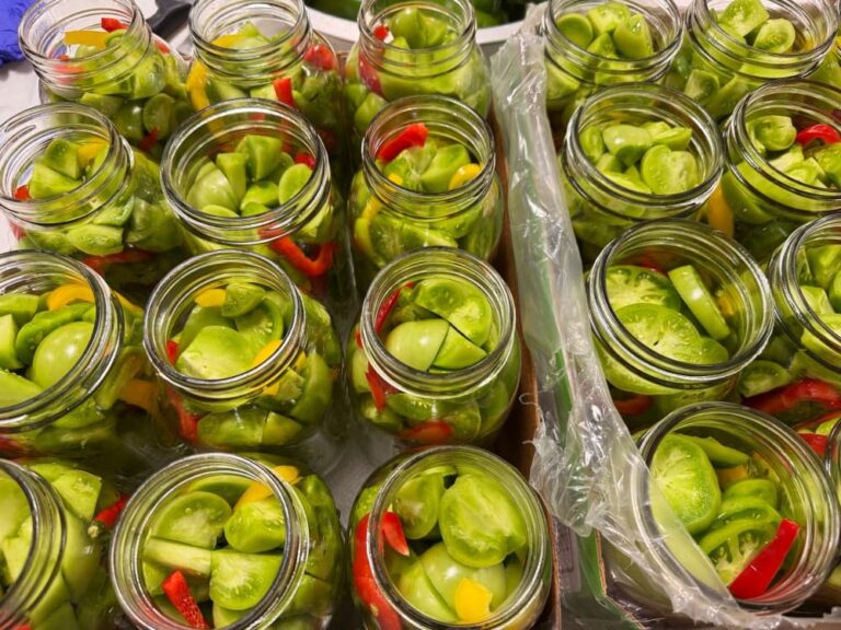 jars filled with green tomatoes and peppers
