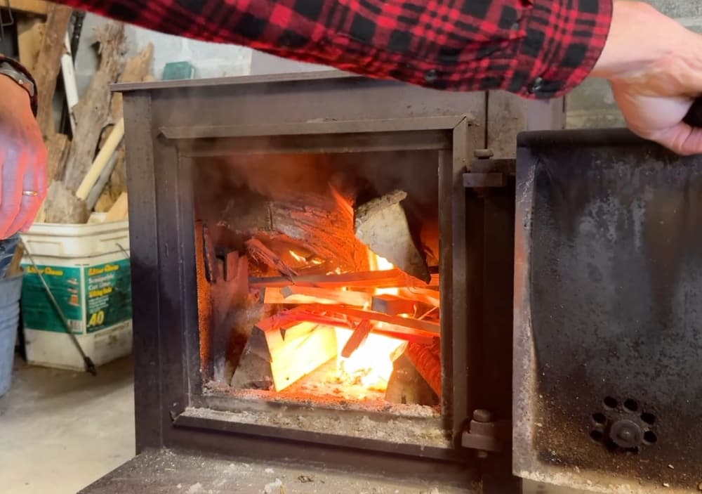 open door of stove with fire burning