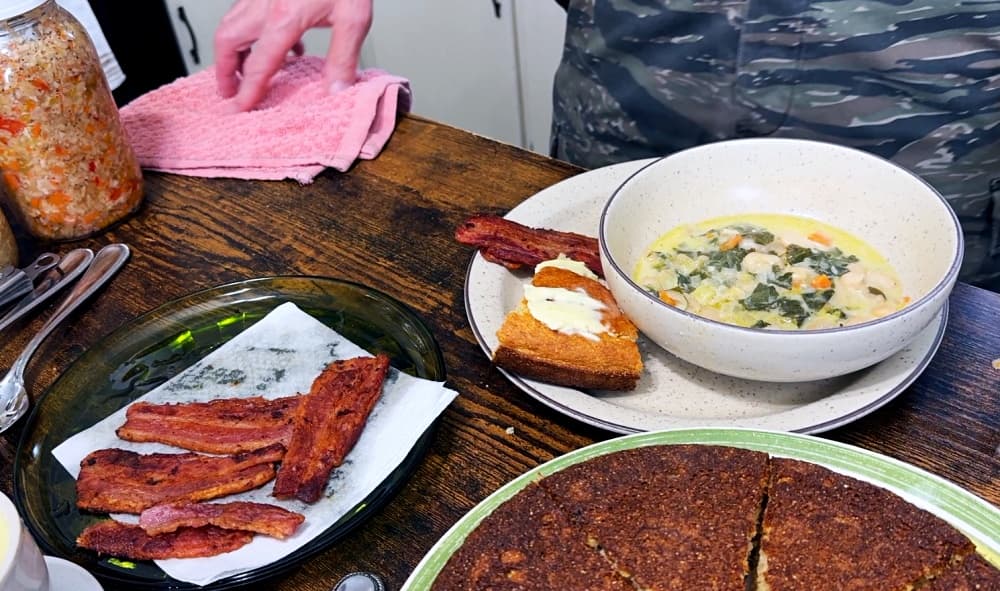 man putting food on plate