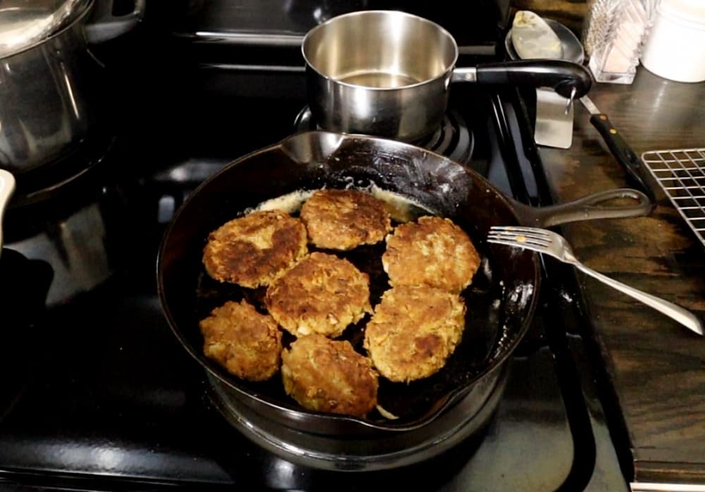 Salmon Patties frying in pan