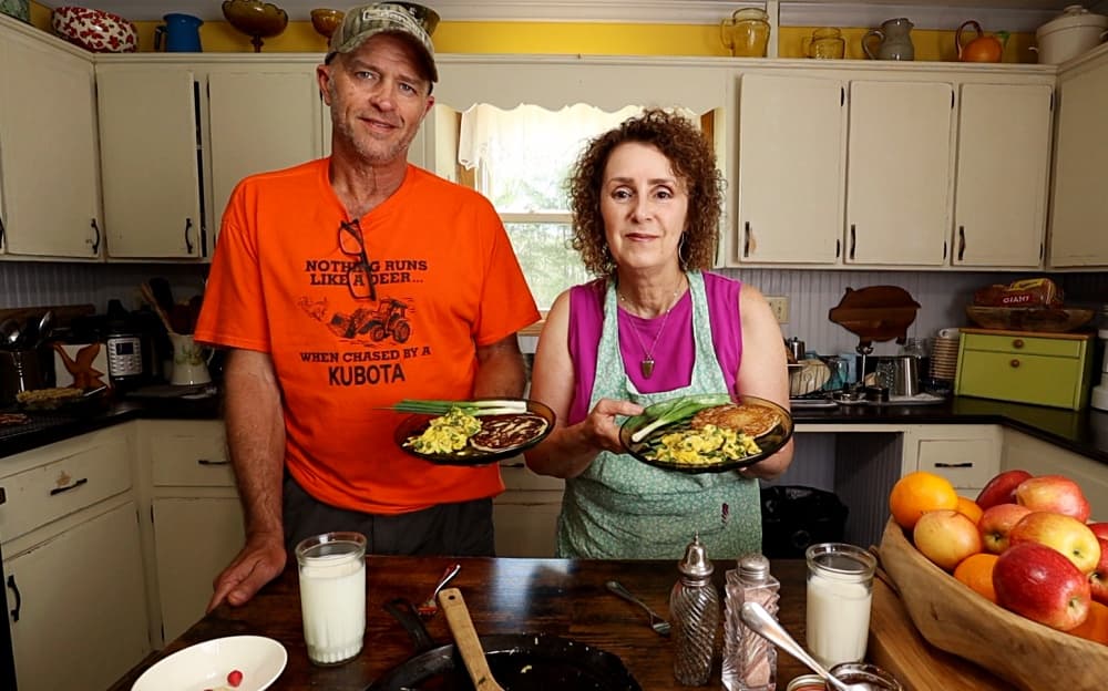 man and woman with plates of food